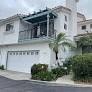 a white house with a palm tree in front of it