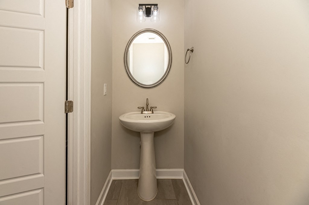 a small bathroom with a sink and a mirror