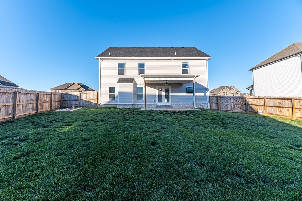 the back yard of a house with a fenced in yard