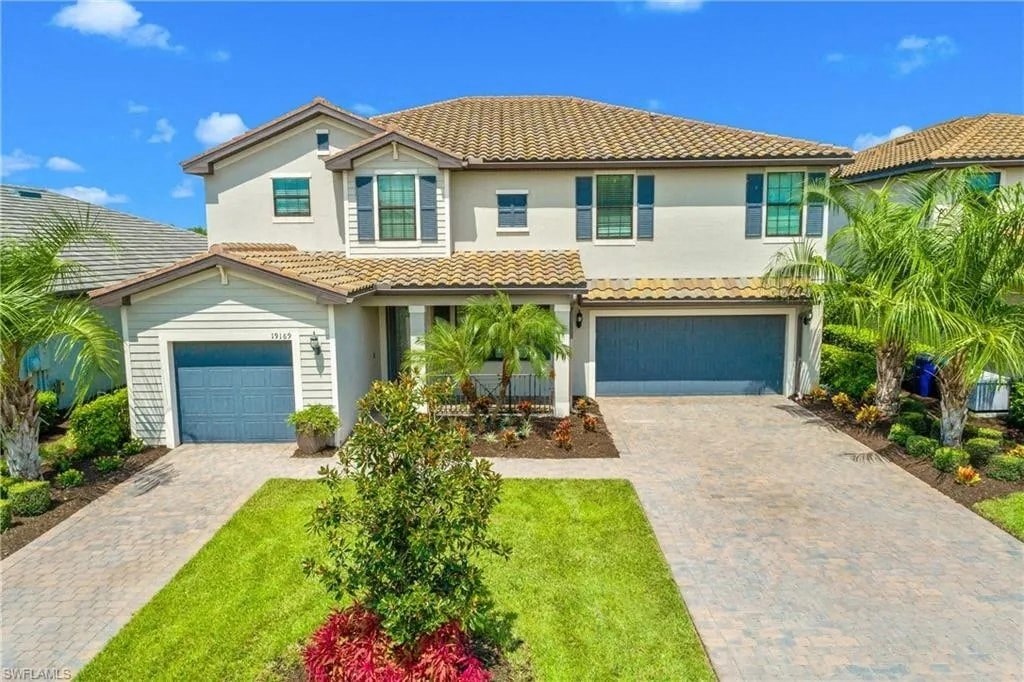 a house with two garage doors and a driveway