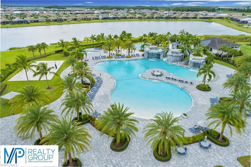 an aerial view of a large swimming pool with palm trees