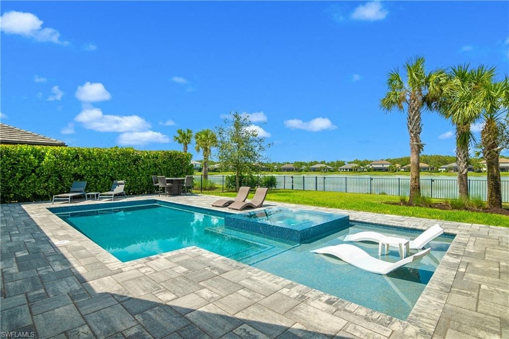 a swimming pool with palm trees and chairs around it