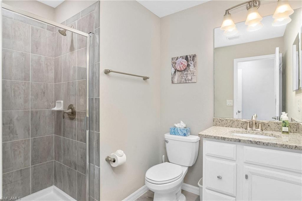a bathroom with a shower toilet and a sink