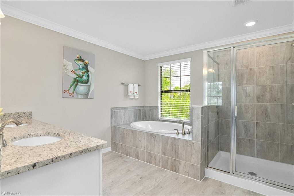 a bathroom with a tub and a shower and a sink