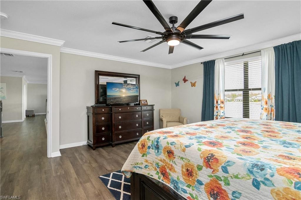 a bedroom with a large bed and a ceiling fan