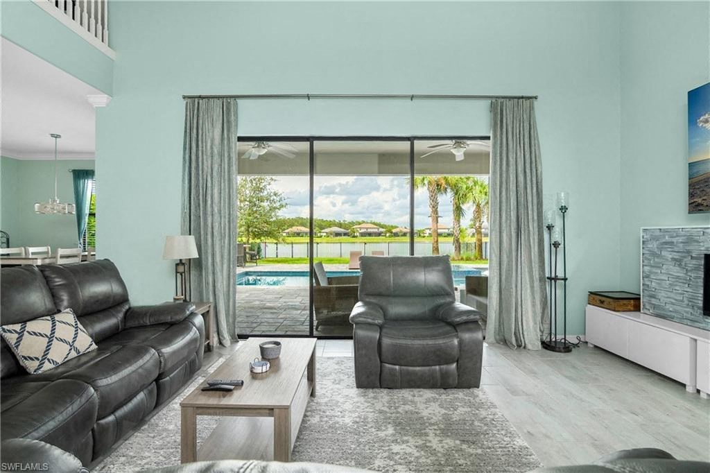 a living room with a view of a pool and a couch and a table