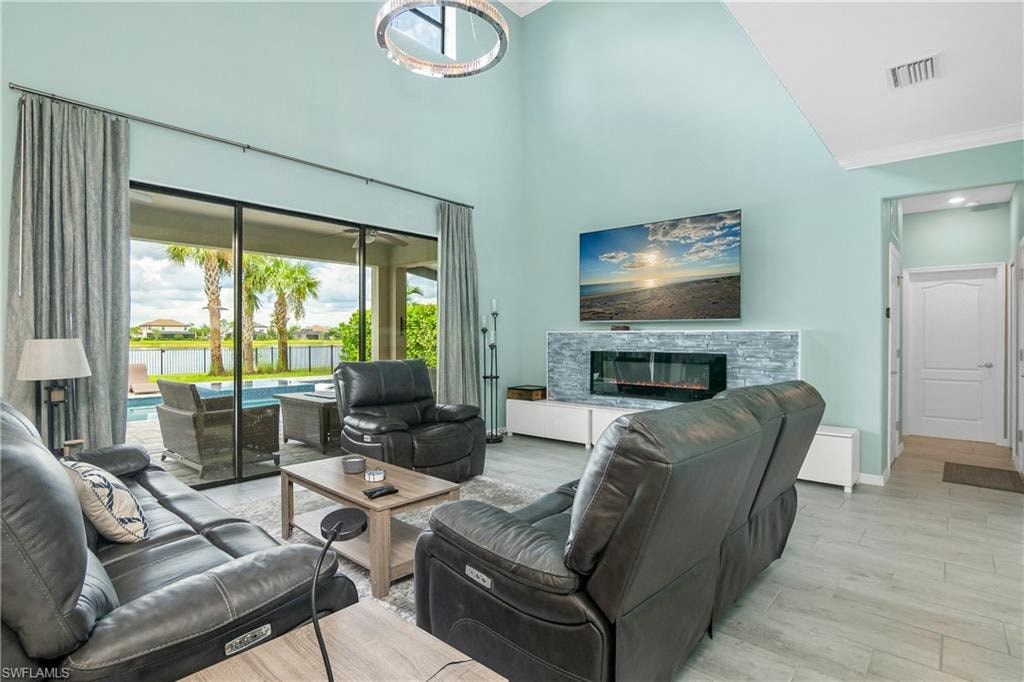 a living room with leather furniture and a fireplace