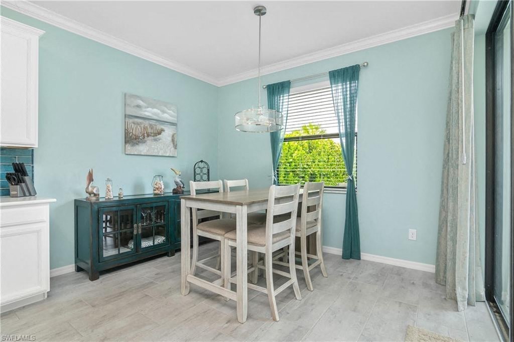 a dining room with a table and chairs and a window