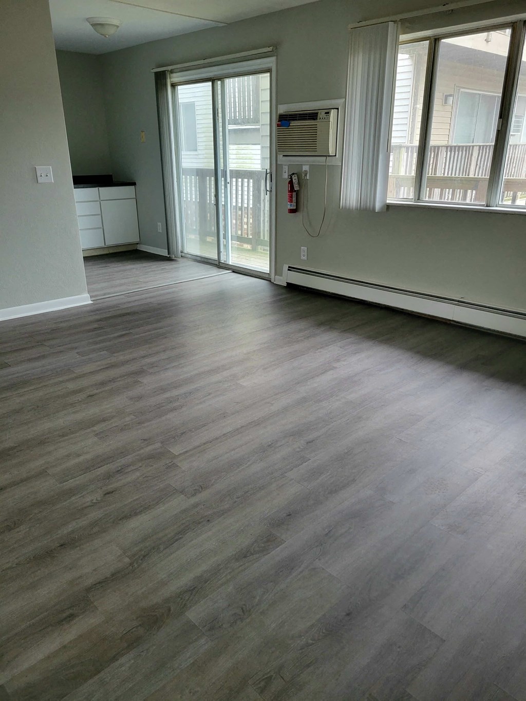 the living room of an empty house with a wood floor