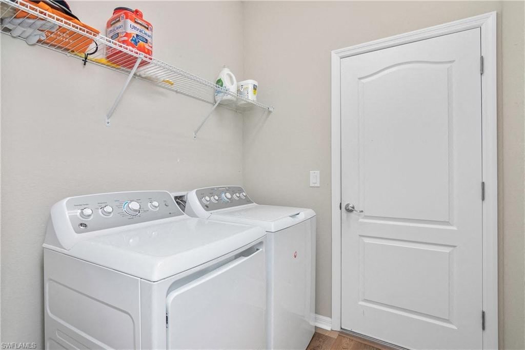 a white washer and dryer in a laundry room with a white door