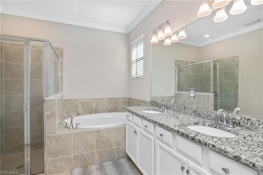 a bathroom with a tub and a sink and a mirror