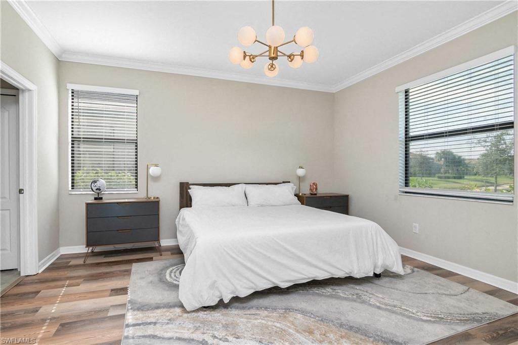 a bedroom with a bed and a chandelier