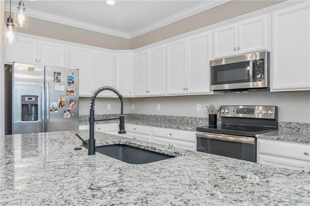 a kitchen with marble counter tops and a sink