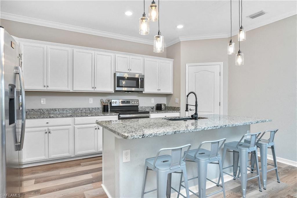 a kitchen with white cabinets and a counter top