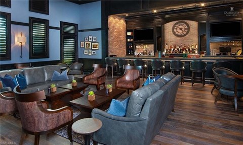 the lobby of a bar with couches and tables