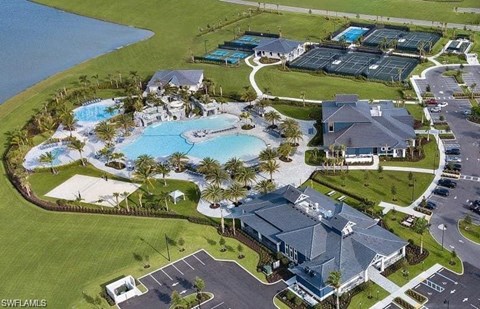an aerial view of a resort with a large swimming pool