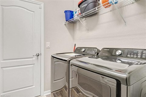 a washer and dryer in a laundry room next to a closet