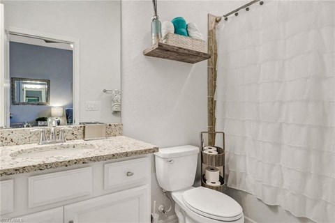 a white bathroom with a shower and a toilet
