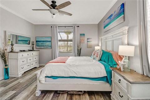 a bedroom with a bed and a ceiling fan