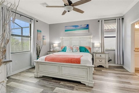 a bedroom with a bed and a ceiling fan