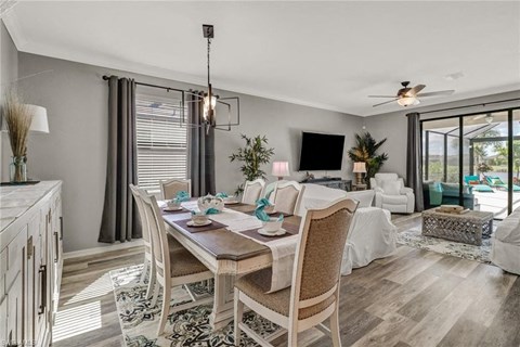 a dining room and living room with a table and chairs