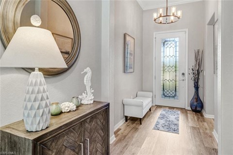 a hallway with a white door and a lamp and a mirror