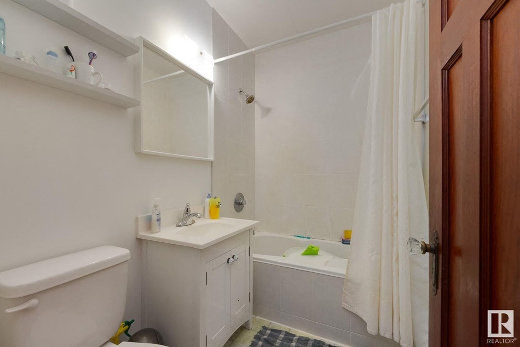 a bathroom with a sink toilet and bath tub
