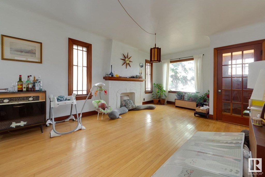 a living room with a fireplace and a wooden floor