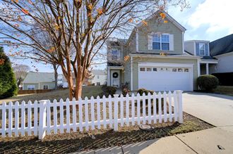 a white picket fence in front of a house