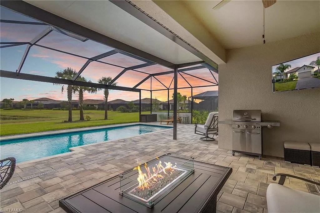 a patio with a fire pit and a swimming pool