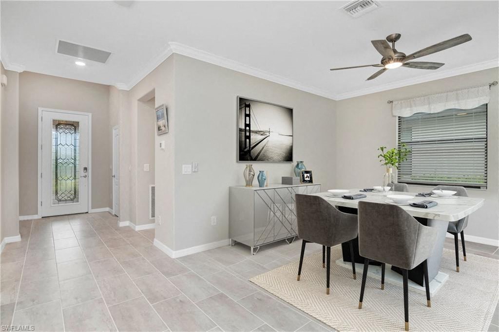 a dining room with a table and chairs and a ceiling fan