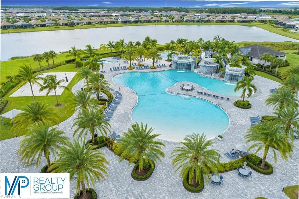 an aerial view of a large swimming pool with palm trees