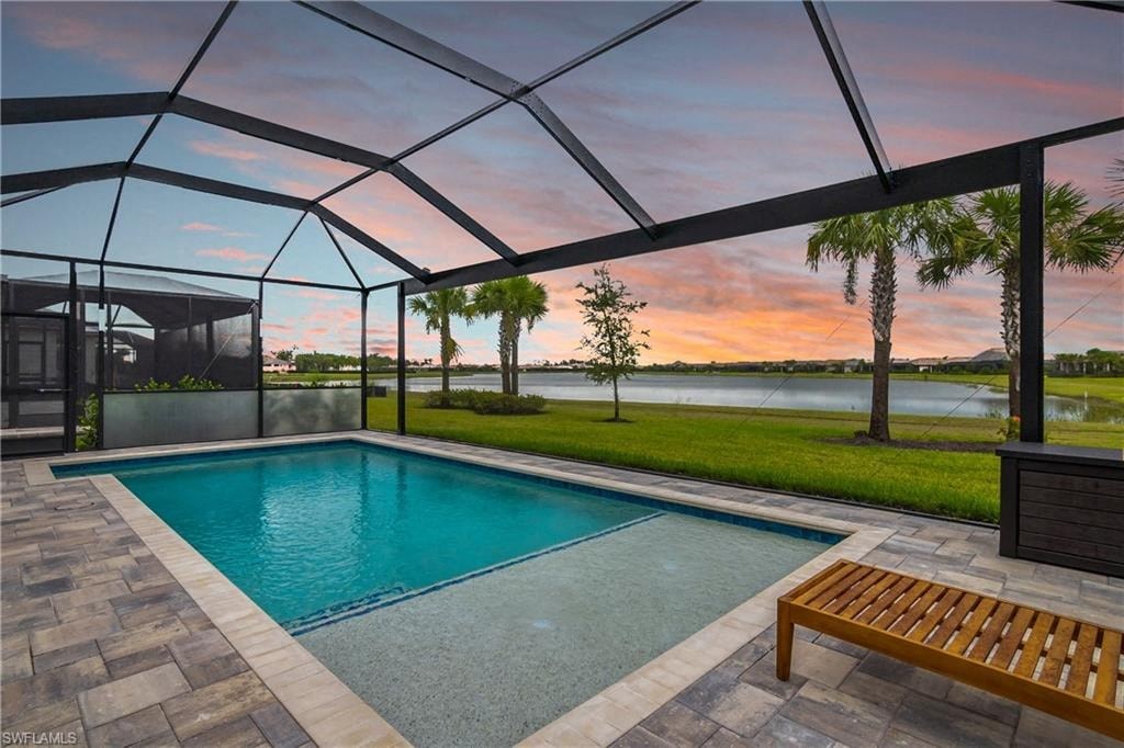 a swimming pool with a sunset in the background