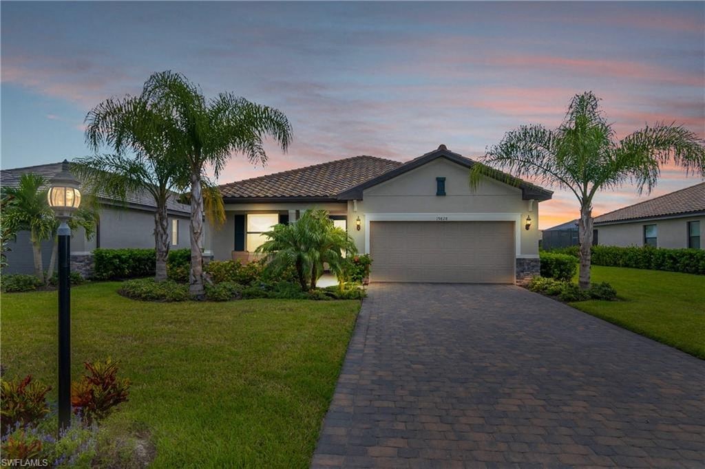 a house with a driveway and palm trees