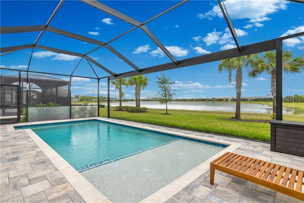 a pool is under a glass roof with palm trees