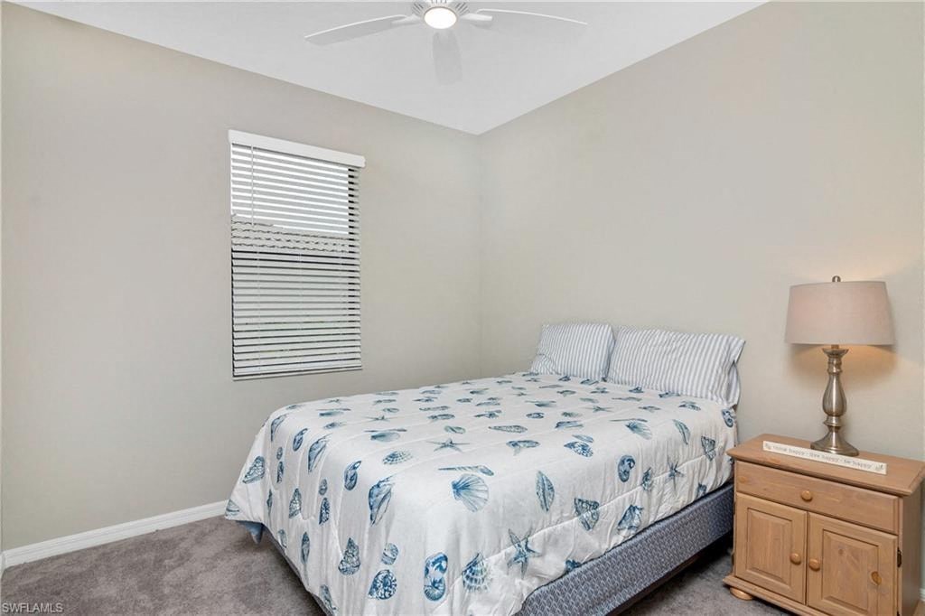 a bedroom with a bed and a ceiling fan