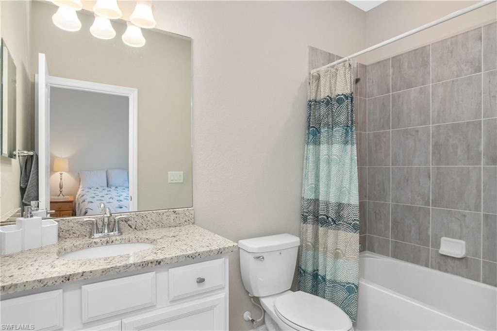 a bathroom with a sink toilet and a mirror
