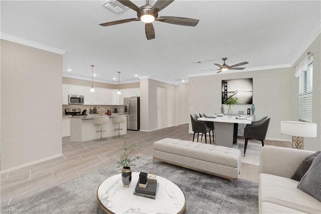 a living room and kitchen with a couch and a table