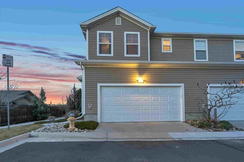 a house with a white garage door at dusk