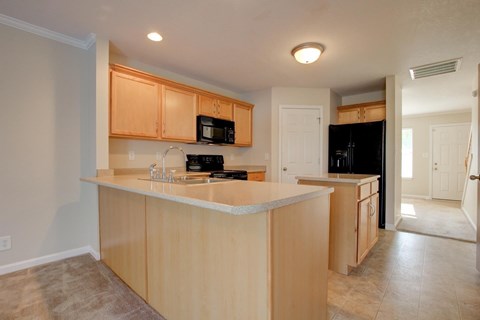 A kitchen with wooden cabinets and a white countertop.