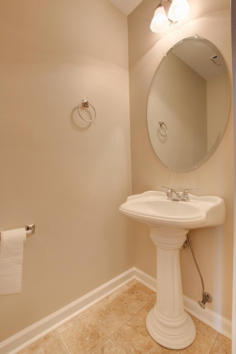A bathroom with a sink and a mirror.