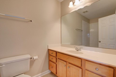 A white toilet sits next to a white sink in a bathroom.