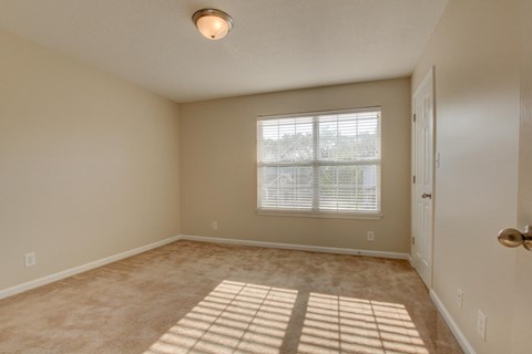 A room with a window and a door.