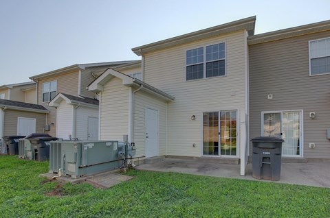 A row of houses with a green lawn in front.