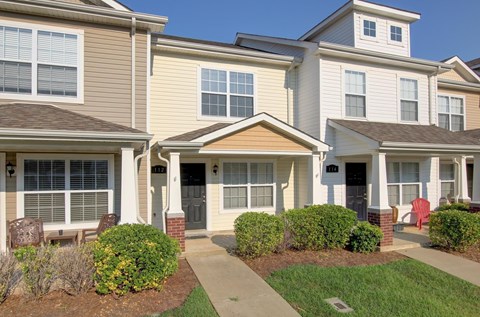 A row of houses with front yards and driveways.
