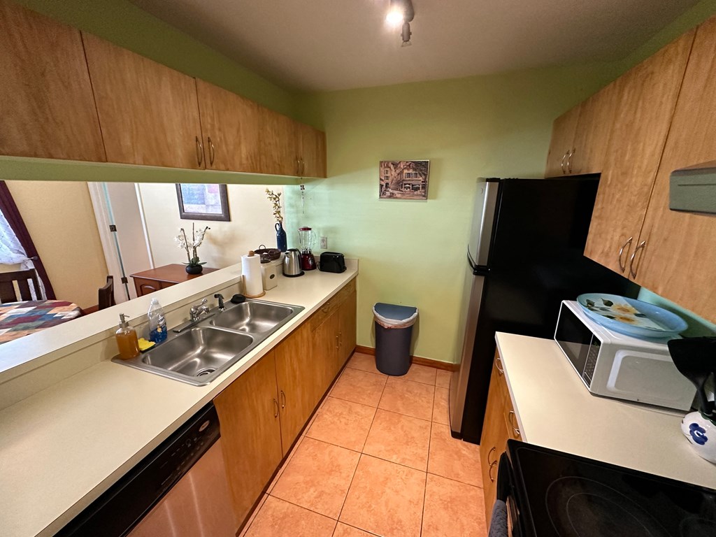 a kitchen with a sink and a refrigerator