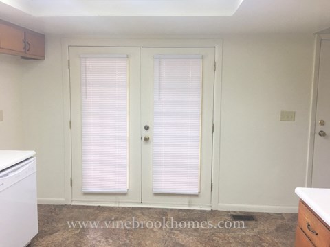 a kitchen with white cabinets and white doors
