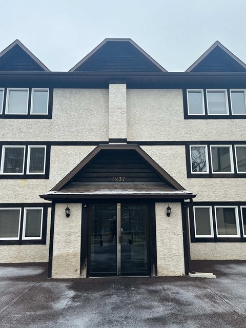 the front of a building with a large door