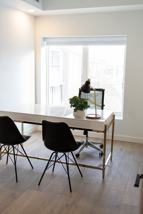 a dining room with a table and chairs and a window