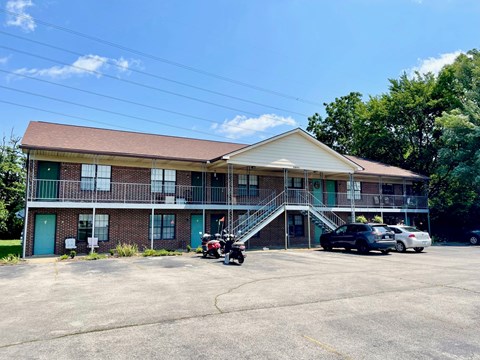 a building with a parking lot and a motorcycle in front of it